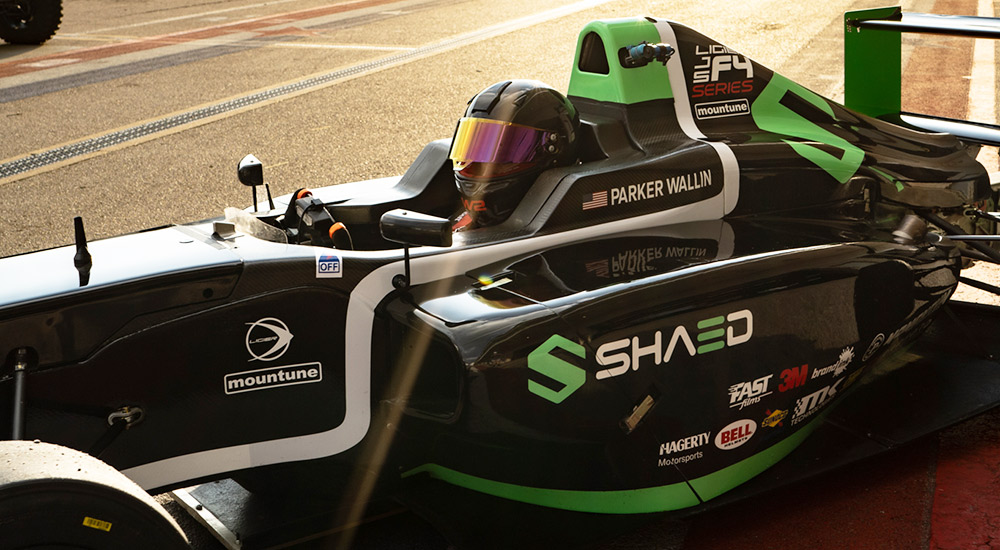 Formula 4 driver in branded race car