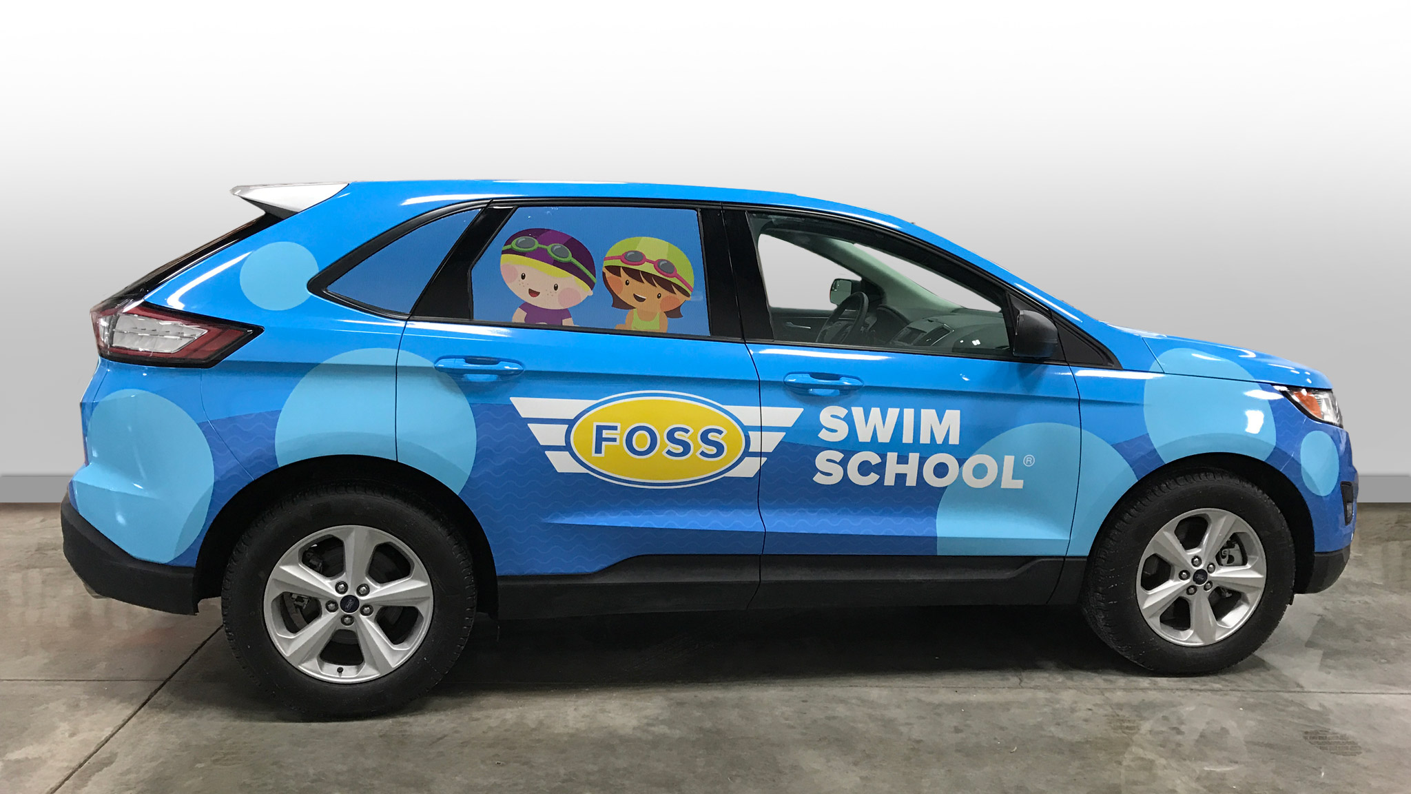 Swim School - branded and wrapped blue car