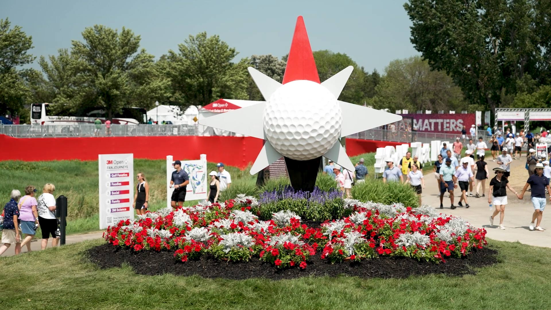 large golf ball display over a bed of flowers