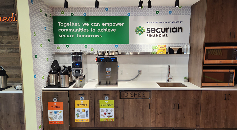 kitchen counter with appliance and wall graphics and signage for receptacles