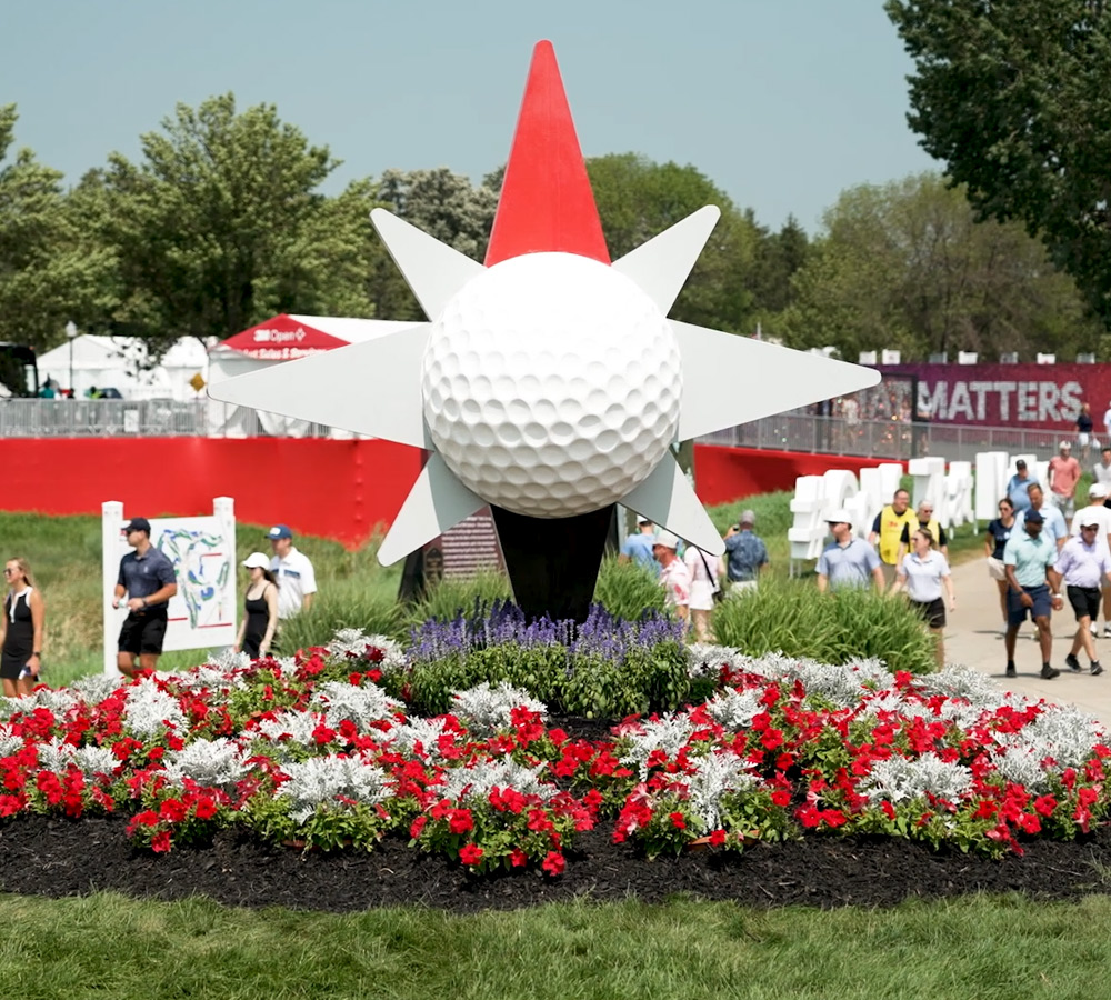 large golf ball display over a bed of flowers