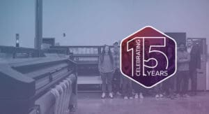 Brand Ink team photo with an overlay of a celebrating 15 years icon