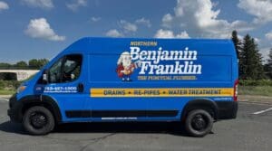 blue van with a commercial vehicle wrap that reads "Northern Benjamin Franklin: The Punctual Plumber - Drains, Re-Pipes, Water Treatment. It also contains a phone number and short website URL.