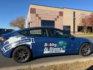 Bobby & Steve’s Auto World branded vehicle parked outside a commercial building in the Twin Cities