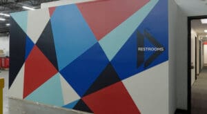 Colorful vinyl wrapped wall and Restroom wayfinding sign that Brand ink installed for Kids in Need Foundation