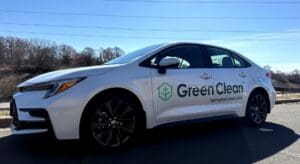 Green Clean branded vehicle wrap on white sedan installed by Brand Ink in Minnesota
