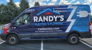 Randy's Electric & Plumbing newest wrapped Ford Transit is showcased in a parking lot against a beautiful blue sky in St Paul, MN